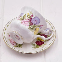 Elegant floral teacup and saucer set with vintage rose and sweet pea design, gold trim, perfect for home décor