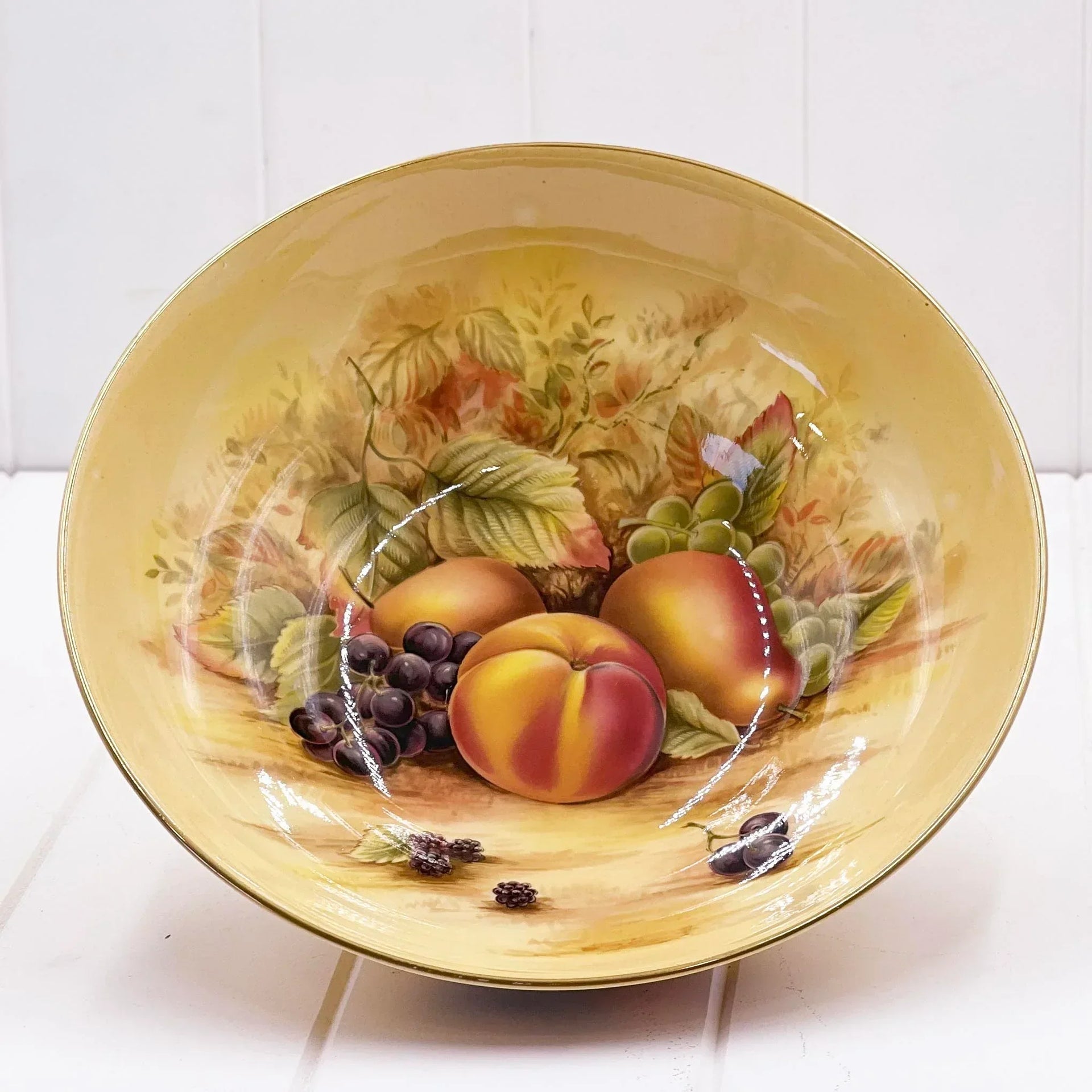 Vintage fruit bowl with hand-painted peaches, grapes, and leaves, gold rim, elegant home decor