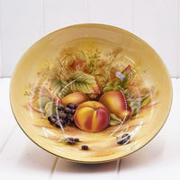 Vintage fruit bowl with hand-painted peaches, grapes, and leaves, gold rim, elegant home decor