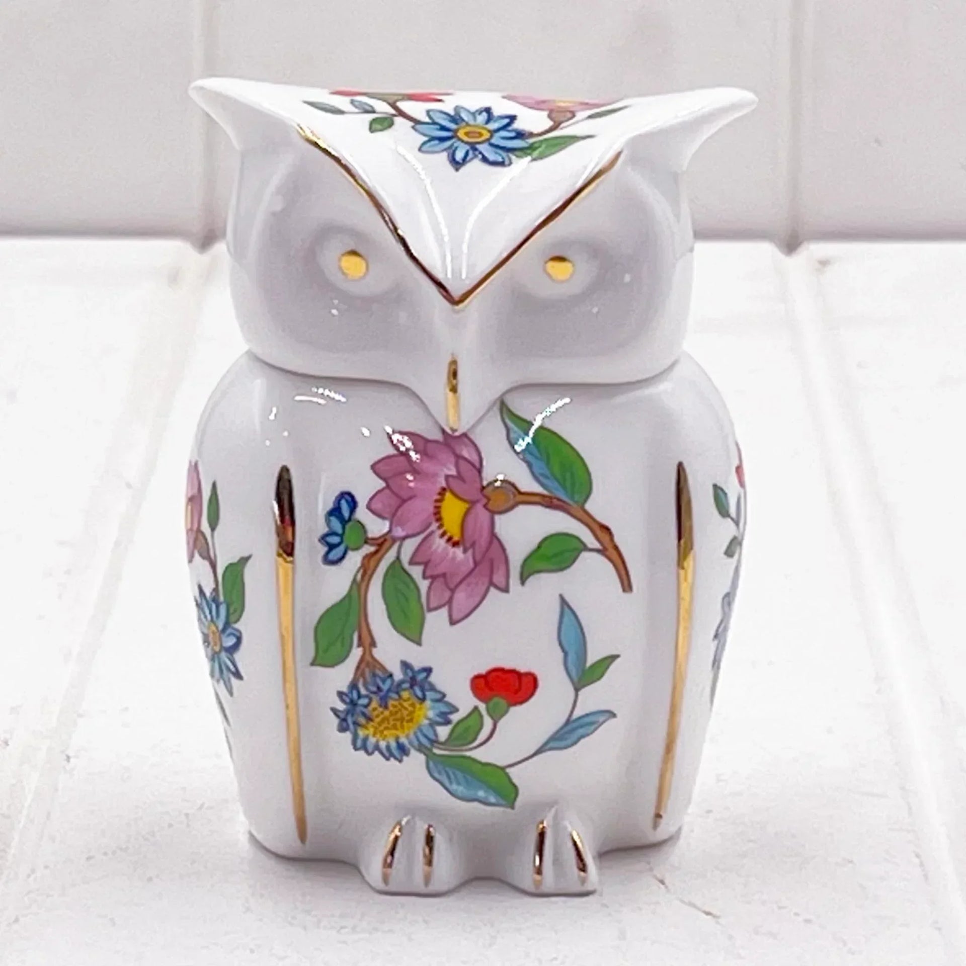 White ceramic owl figurine with hand-painted floral design and gold accents, perfect for home décor