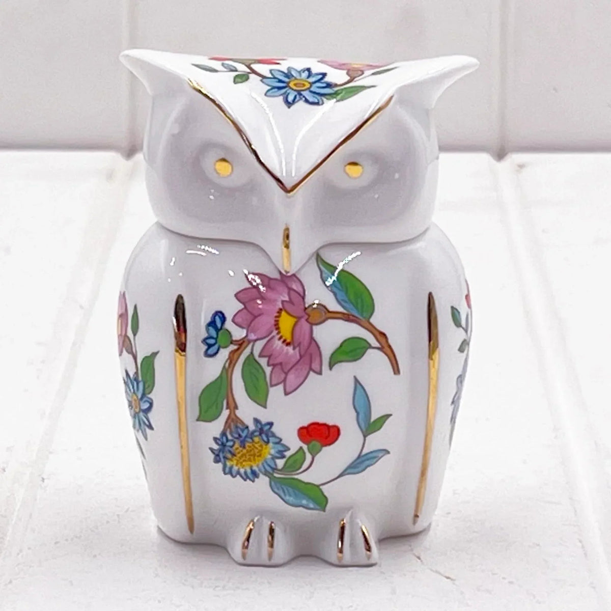 White ceramic owl figurine with hand-painted floral design and gold accents, perfect for home décor