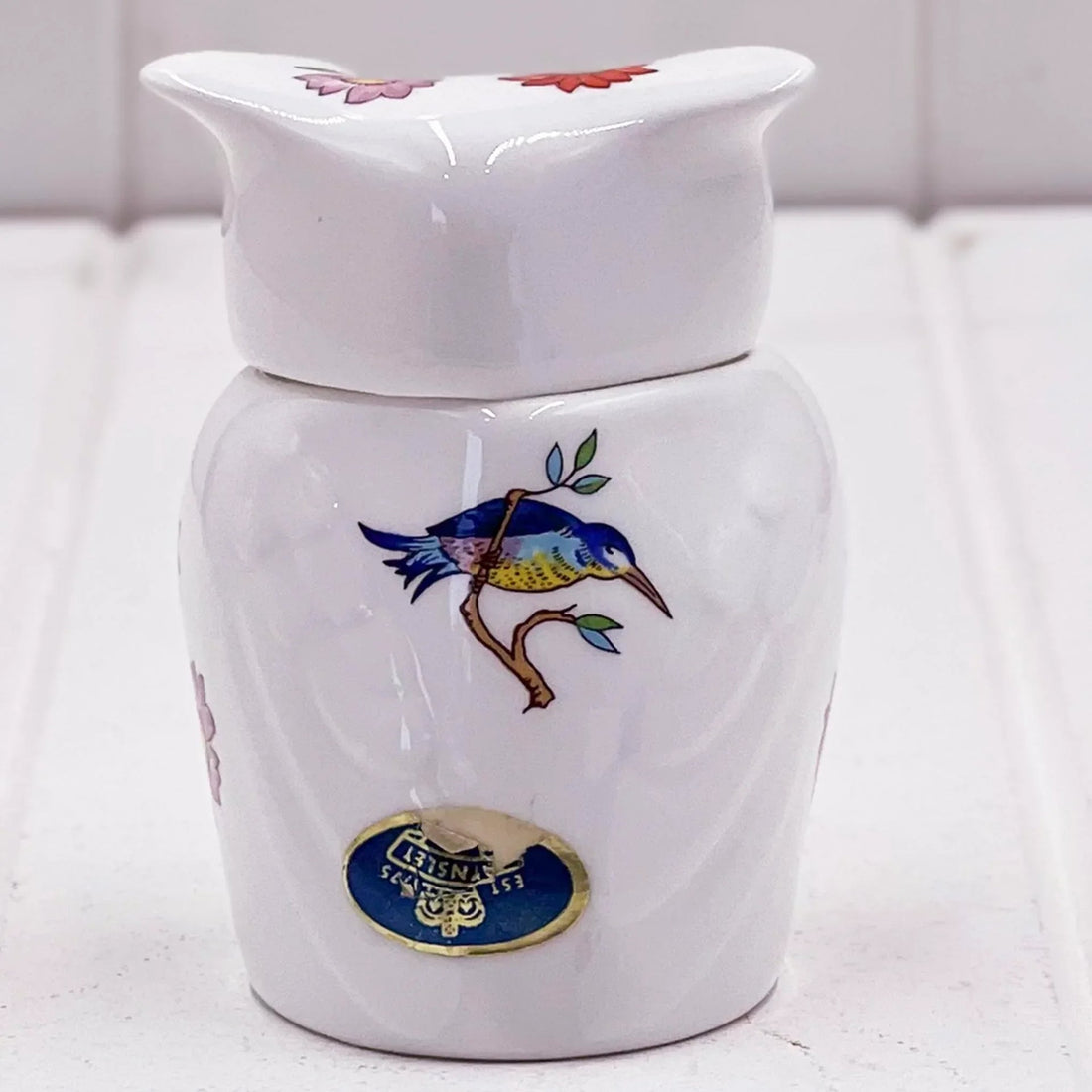 White ceramic jar with blue bird and floral design, vintage-style home decor accent piece