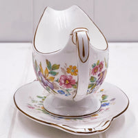 Vintage floral gravy boat with gold trim, elegant porcelain serving piece for home dining decor