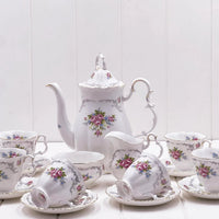 Elegant floral tea set with pink roses, gold trim, teapot, cups, saucers, and creamer for vintage home décor