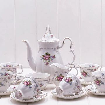 Elegant floral tea set with pink roses, gold trim, teapot, cups, saucers, and creamer for vintage home décor