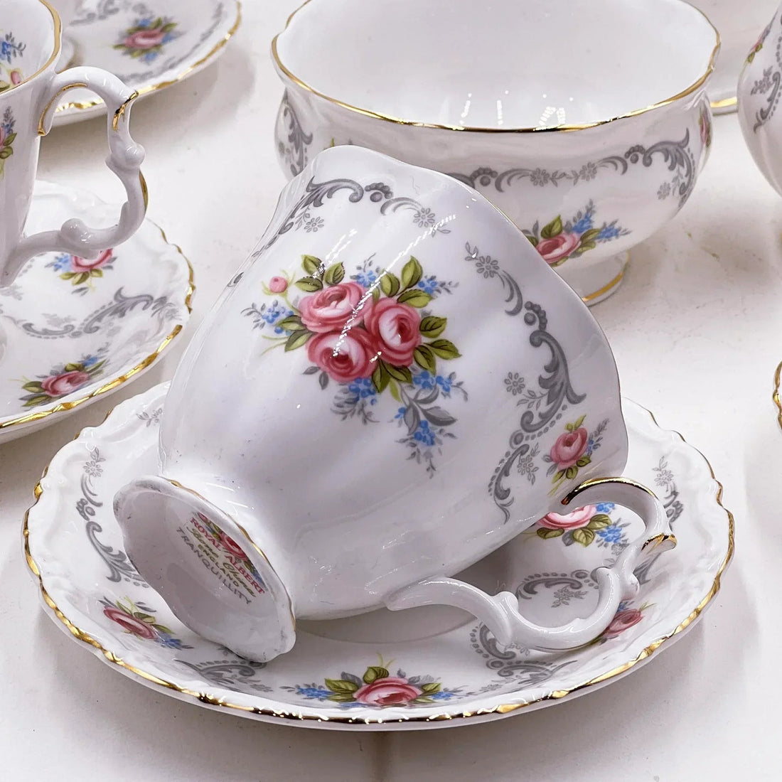 Vintage Royal Albert Tranquillity teacup and saucer with pink roses, gold trim, and grey scrollwork, elegant porcelain tea set