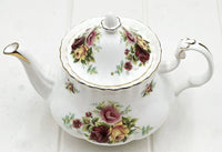 Elegant floral teapot with rose pattern and gold trim, vintage-style home décor