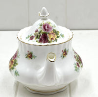 Elegant floral porcelain teapot with gold trim, vintage-style rose pattern, perfect for home décor or tea service.