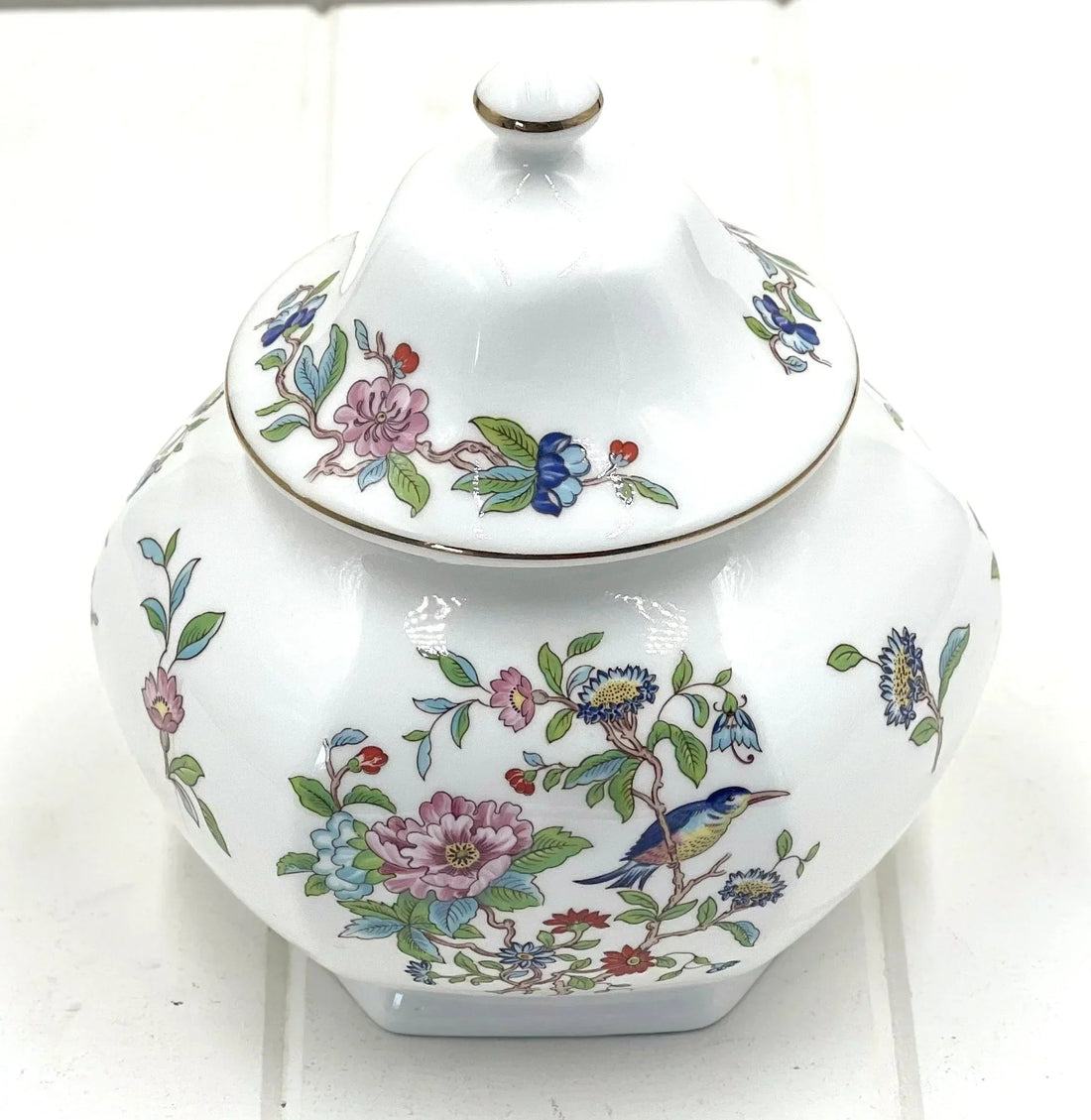 Elegant porcelain jar with floral and bird design, perfect for home décor