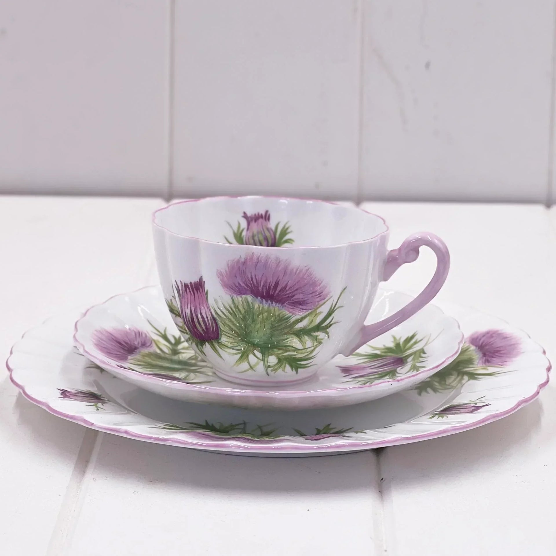 Vintage thistle-patterned teacup and saucer set with purple floral design, elegant home décor