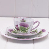 Vintage thistle-patterned teacup and saucer set with purple floral design, elegant home décor