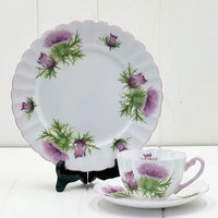 Elegant thistle-patterned porcelain tea set with purple flowers and scalloped edges