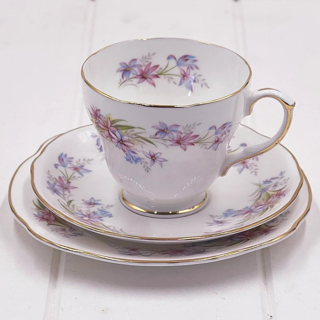 Elegant floral teacup and saucer set with gold trim, vintage-inspired home decor for tea lovers
