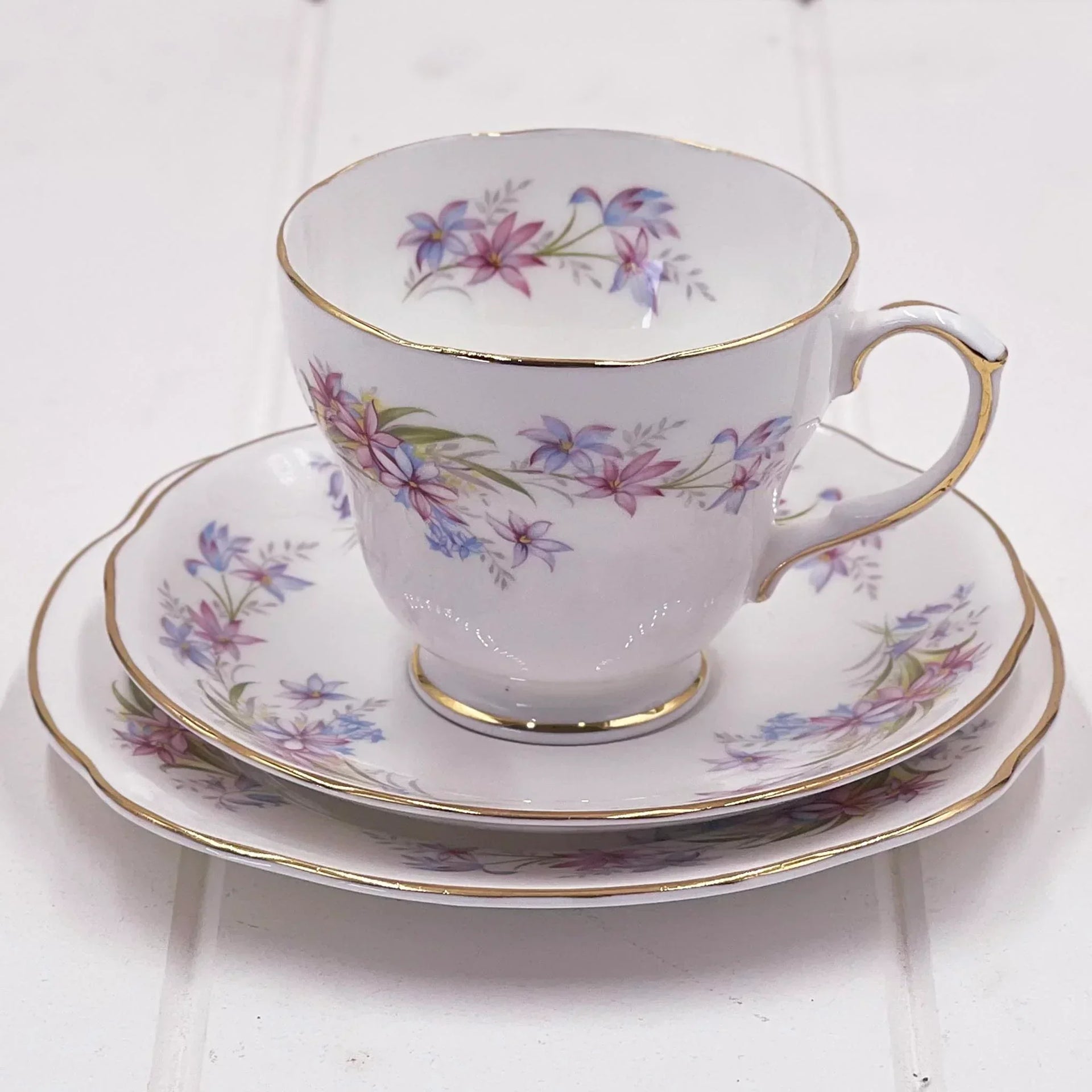 Elegant floral teacup and saucer set with gold trim, vintage-inspired home decor for tea lovers