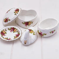 Vintage floral porcelain trinket boxes: heart, swan, and scalloped designs with rose patterns for elegant home décor