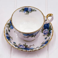 Elegant porcelain teacup and saucer with blue roses and gold trim, vintage-style home décor