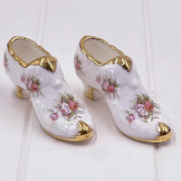 Delicate porcelain shoe figurines with pink roses and gold trim, vintage home décor accent