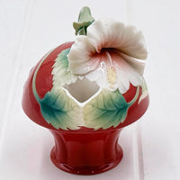 Red ceramic vase with white hibiscus flower and green leaves, vintage home décor accent piece
