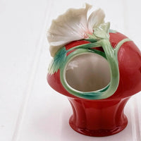 Red ceramic vase with white flower and green leaves, vintage home décor accent piece