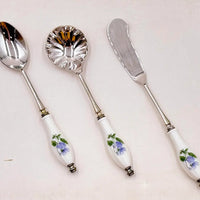Elegant vintage serving set with floral porcelain handles and silver-toned metal, perfect for home décor