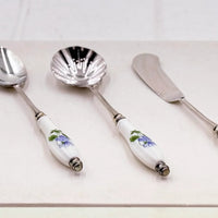 Elegant vintage serving set with floral porcelain handles and silver-toned metal, perfect for home décor