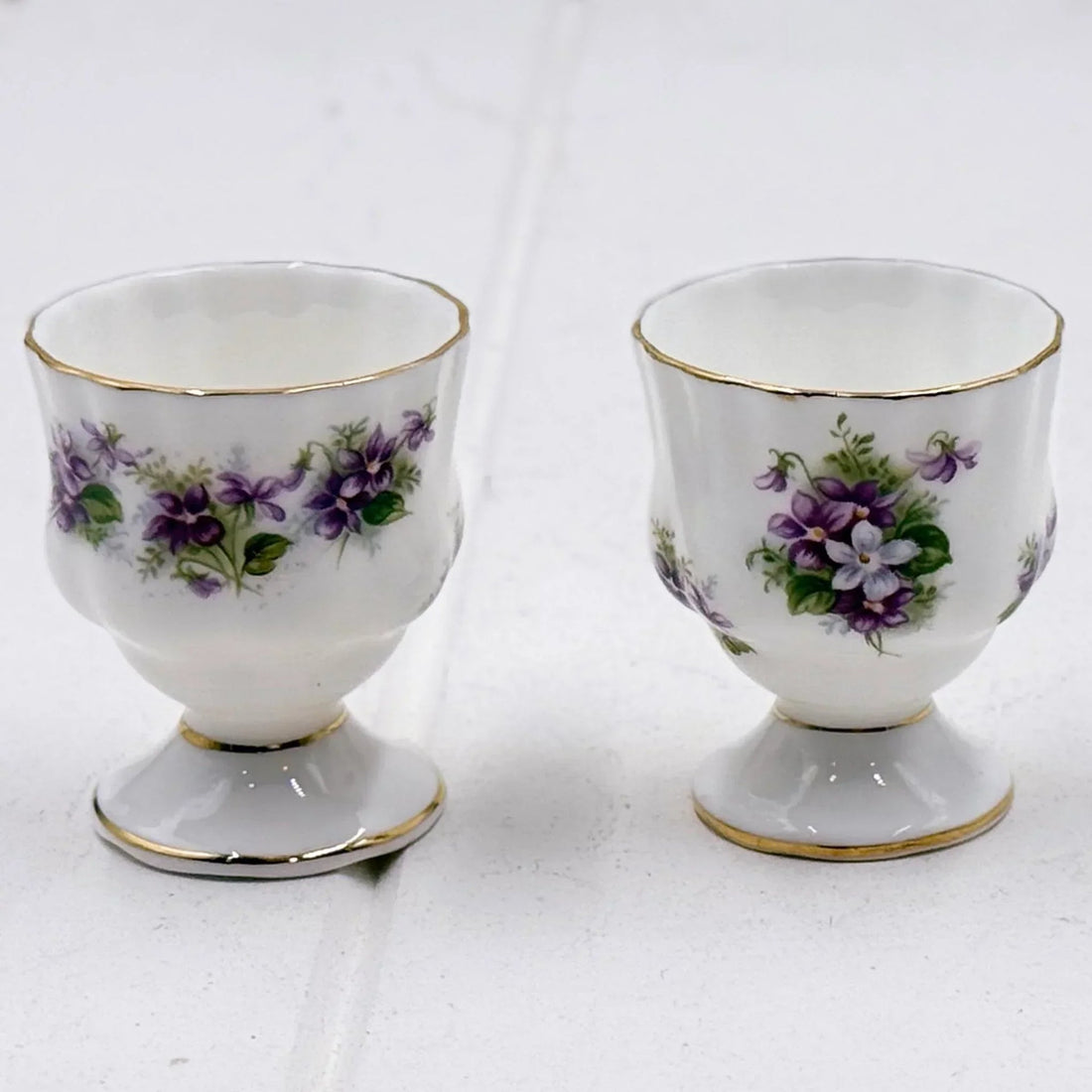 Elegant porcelain egg cups with purple violet floral design and gold trim, vintage homeware decor