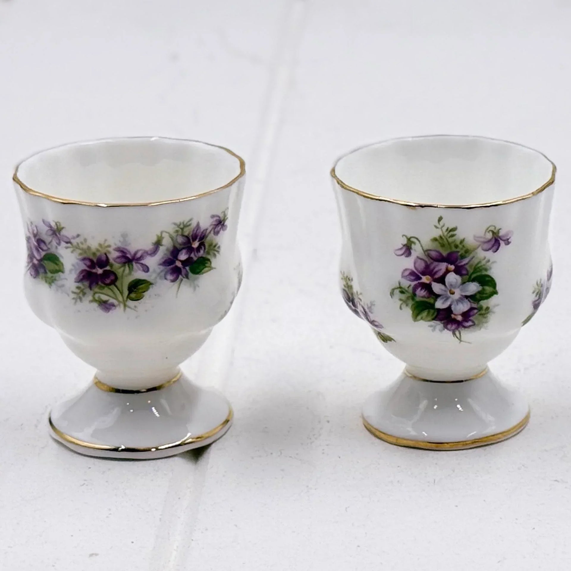 Elegant porcelain egg cups with purple violet floral design and gold trim, vintage homeware decor