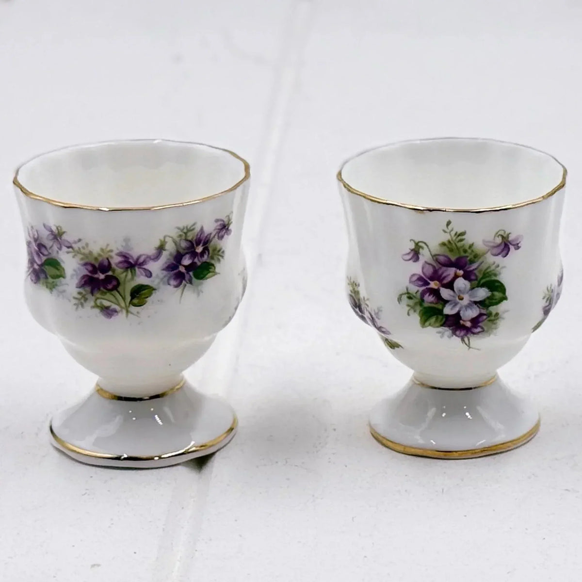 Elegant porcelain egg cups with purple violet floral design and gold trim, vintage homeware decor