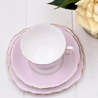 Elegant pink teacup and saucer set with gold trim, perfect for vintage home décor and afternoon tea.