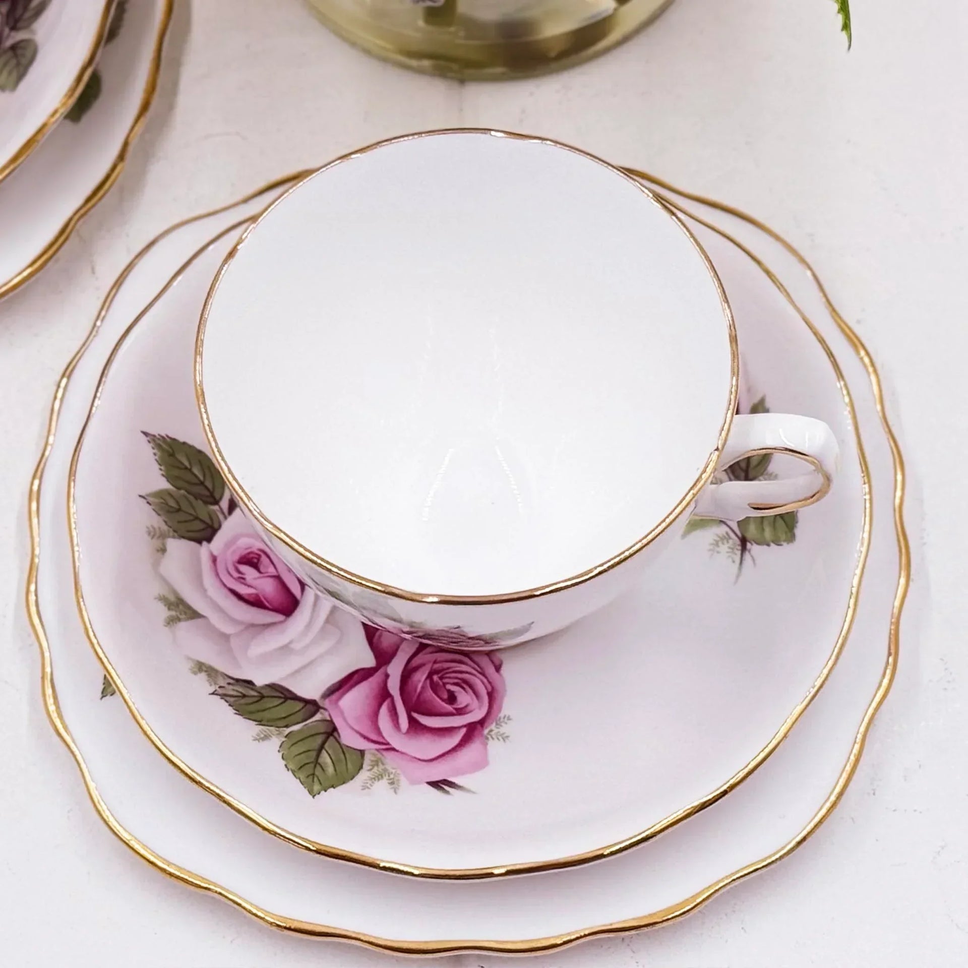 Elegant vintage teacup and saucer set with pink roses and gold trim, perfect for afternoon tea