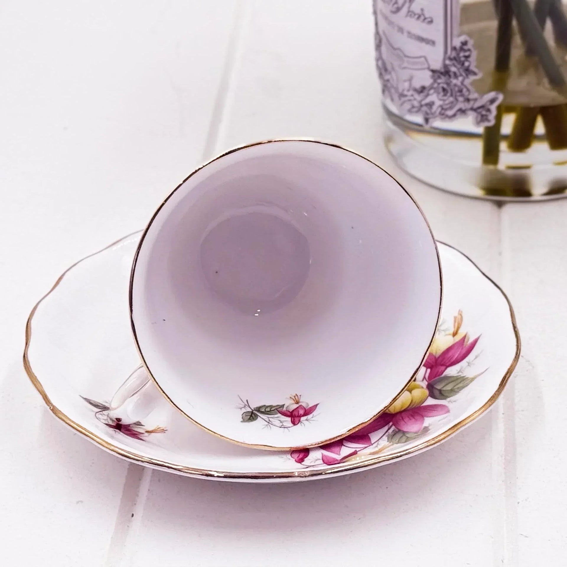 Delicate floral teacup and saucer with gold trim, vintage home decor accent
