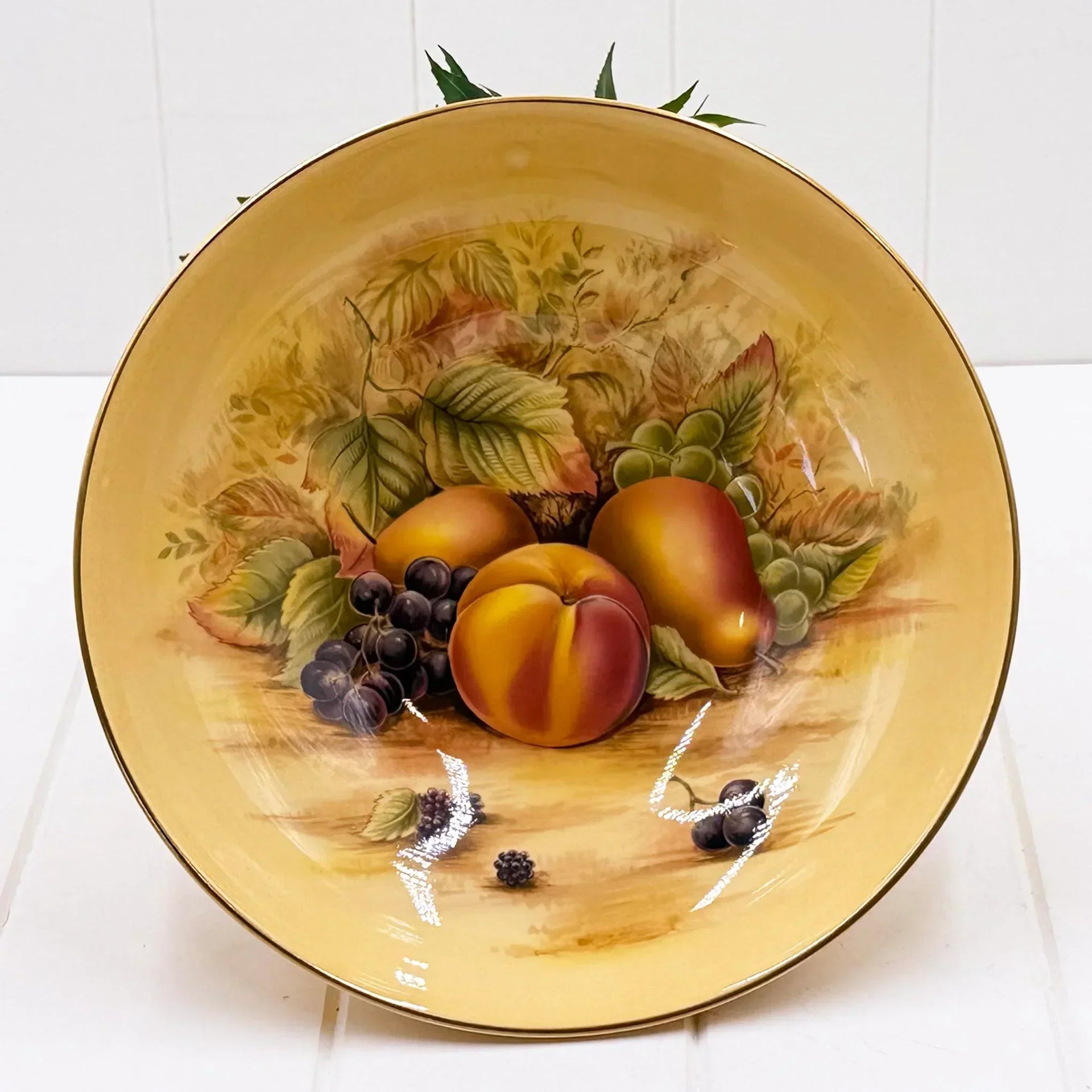 Vintage fruit platter with peaches, grapes, and leaves, gold rim, home décor accent piece