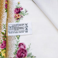 Floral tea towel with gold trim, care label showing 50% cotton 50% polyester, made in Great Britain