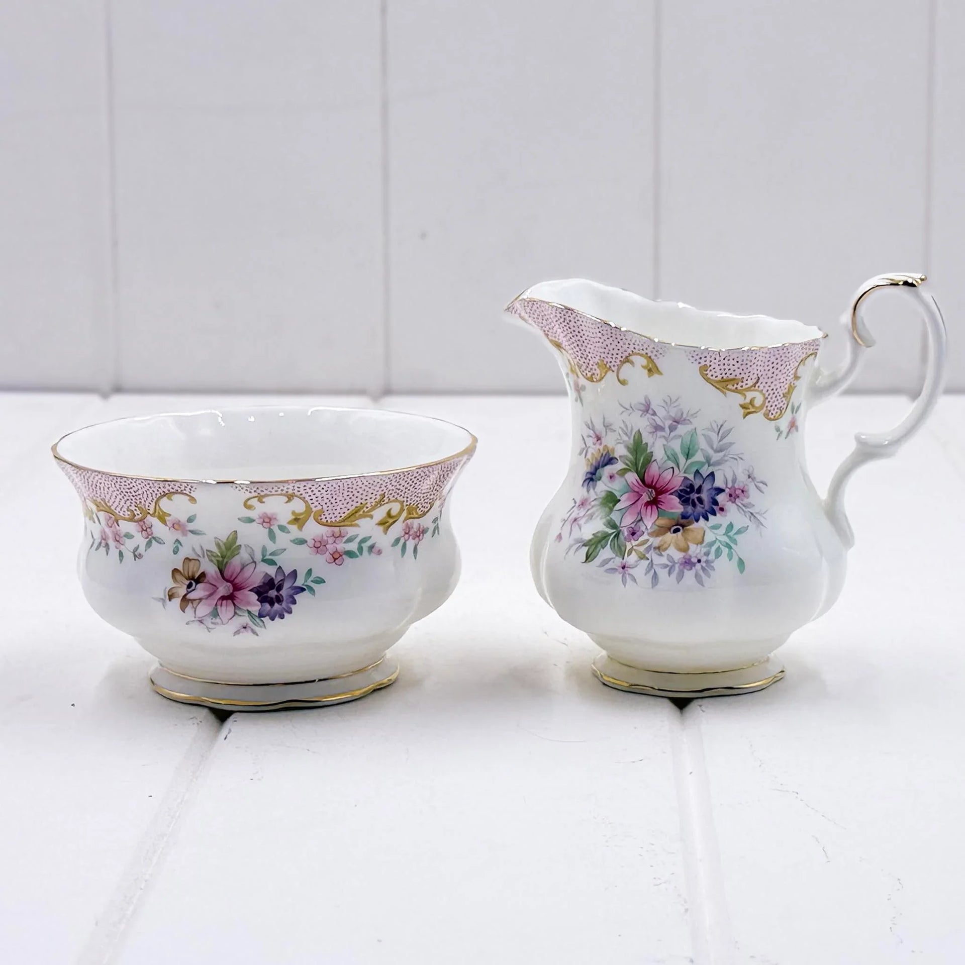 Elegant floral porcelain creamer and sugar bowl set with gold trim, vintage home décor