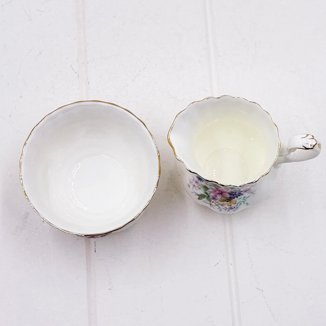 Elegant floral teacup and saucer set with gold trim, vintage-inspired home décor