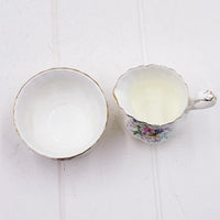 Elegant floral teacup and saucer set with gold trim, vintage-inspired home décor