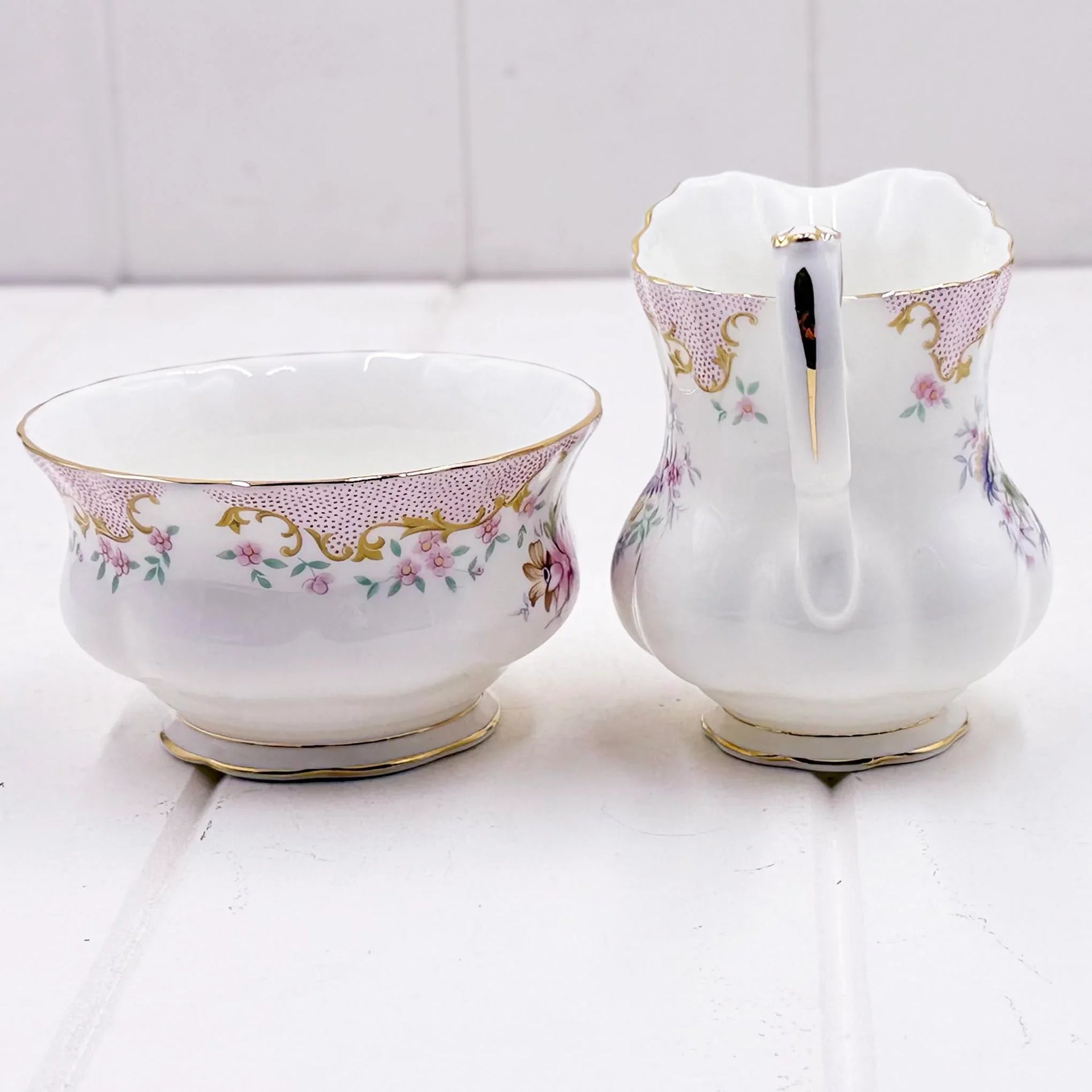 Elegant porcelain creamer and sugar bowl set with pink floral and gold trim, vintage home decor