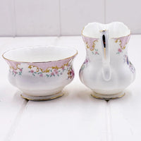 Elegant porcelain creamer and sugar bowl set with pink floral and gold trim, vintage home decor
