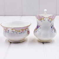 Elegant floral porcelain sugar bowl and creamer set with gold trim, vintage home decor