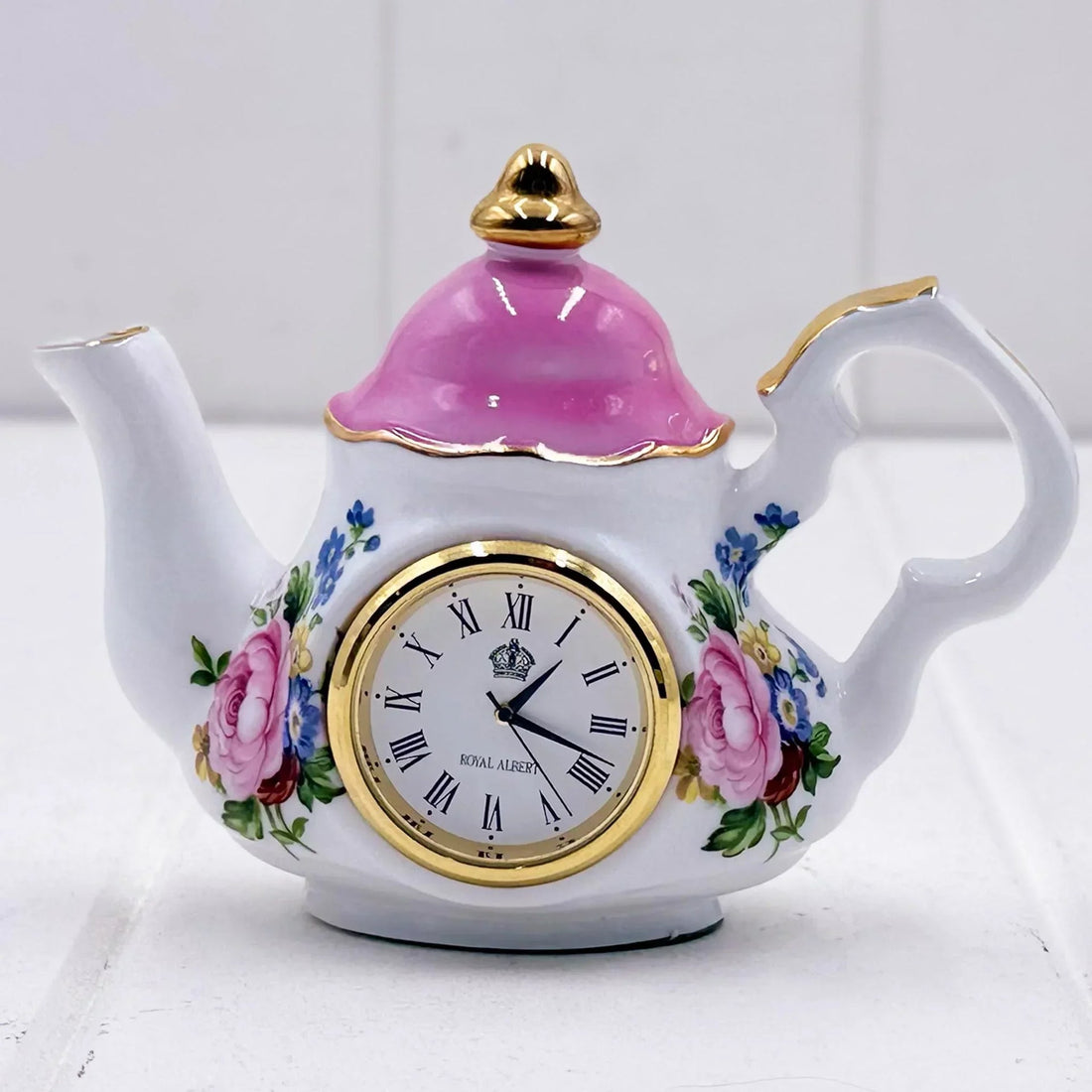 Royal Albert teapot clock with pink lid, floral design, and gold trim, elegant home decor piece