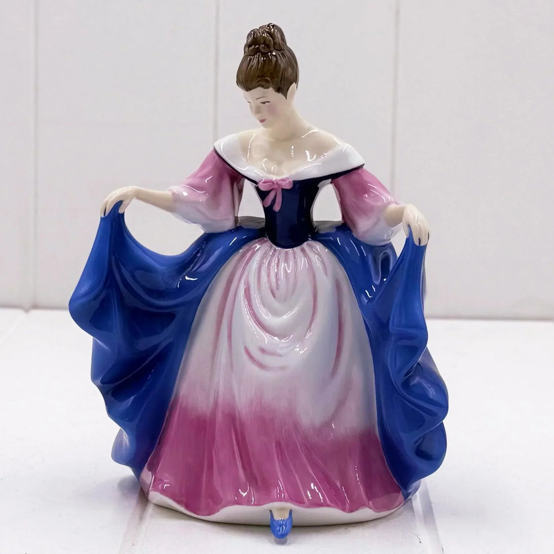 Elegant porcelain figurine of a lady in pink and blue gown, vintage home décor accent piece