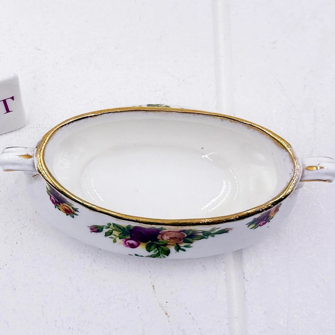 Vintage porcelain dish with floral roses, gold trim, and handles for elegant home décor
