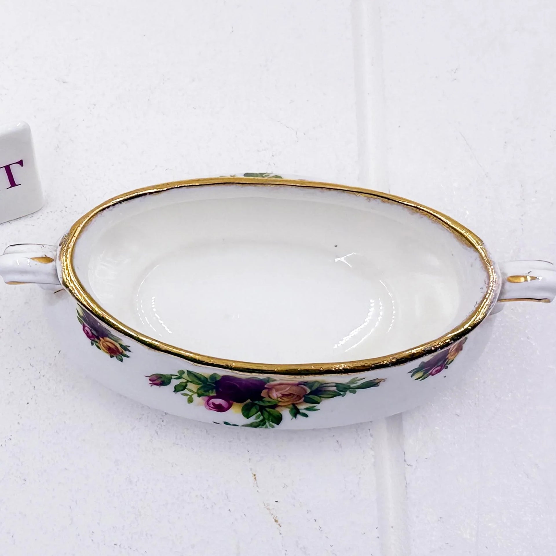 Vintage porcelain dish with floral roses, gold trim, and handles for elegant home décor