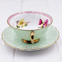 Mint green vintage teacup with floral interior, gold trim, and scalloped saucer for elegant home décor
