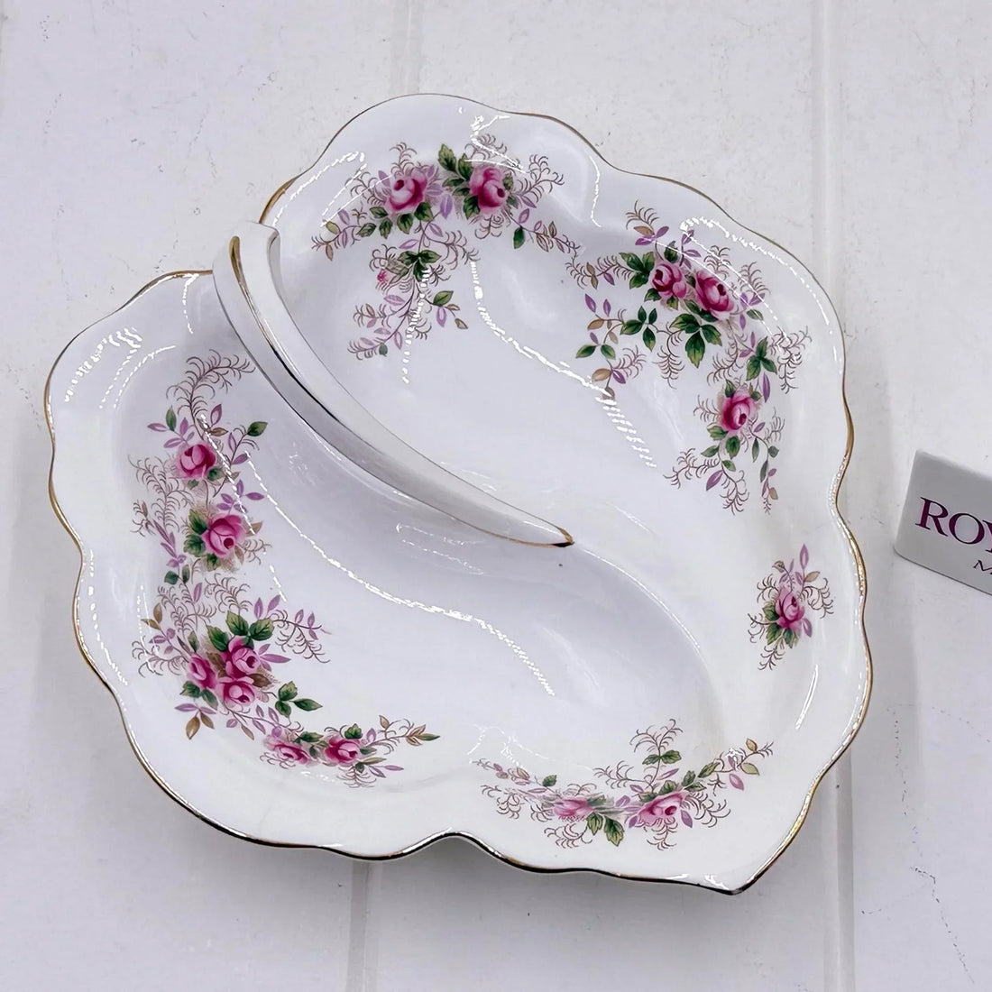 Elegant vintage porcelain dish with pink rose floral pattern and gold trim, perfect for home décor