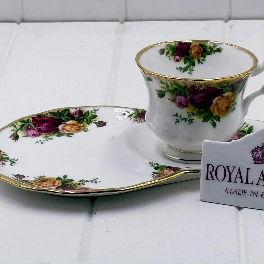 Royal Albert teacup and saucer with vintage rose floral pattern and gold trim, classic home décor