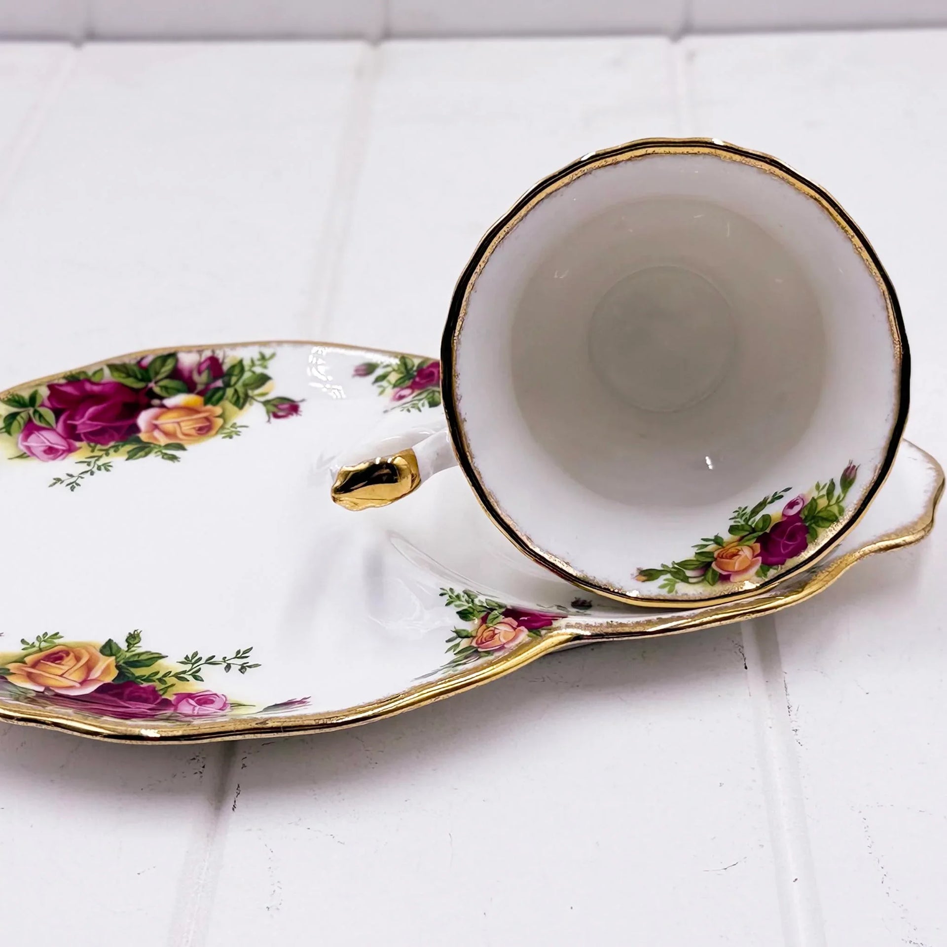 Elegant floral teacup and saucer set with gold trim, vintage-style rose pattern, perfect for home décor