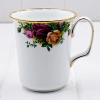 Elegant white porcelain mug with gold trim and vintage rose floral design, perfect for home décor