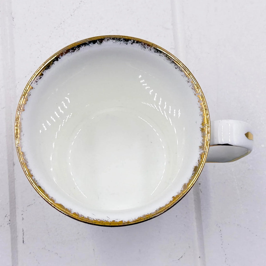 White ceramic cup with gold rim, elegant home decor accessory