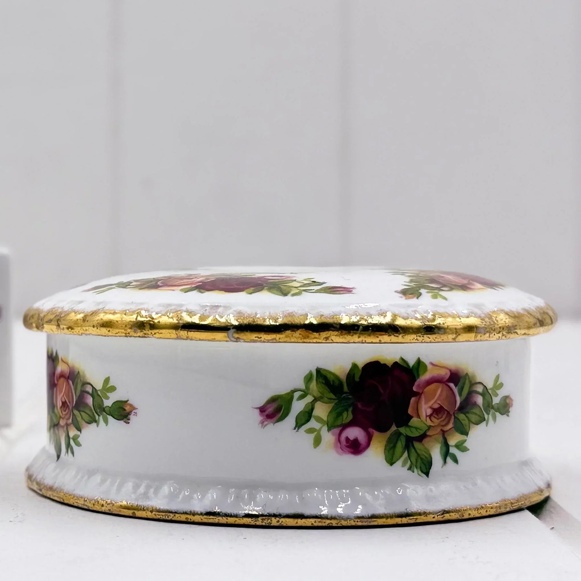 Elegant porcelain trinket box with hand-painted roses and gold trim, vintage home decor accent